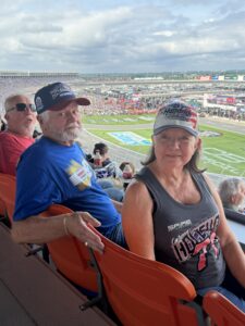 Two RaceAway guests sit in the grandstands at Charlotte Motor Speedway during the 2026 Coca-Cola 600.