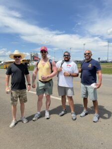 Four RaceAway guests pose for a photo outside Nashville Superspeedway during the 2026 Cracker Barrel 400 weekend.