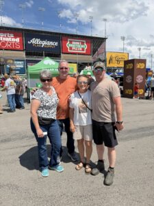 Four RaceAway guests pose in the fan midway at Nashville Superspeedway during the 2026 Cracker Barrel 400 weekend.