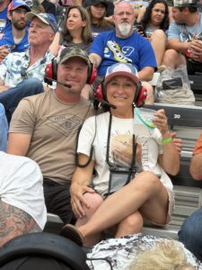 Two RaceAway guests smile from the grandstands at Nashville Superspeedway during the 2026 Cracker Barrel 400.