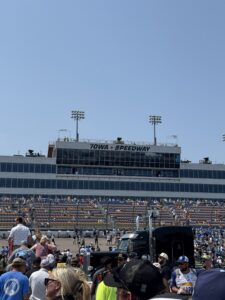 A view of the Iowa Speedway grandstands and main tower during the 2026 Iowa Corn 350 weekend, with fans gathering near the track.