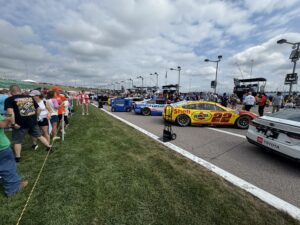 NASCAR Cup Series cars, including the No. 22 Shell-Pennzoil Ford, line the pre-race grid at Kansas Speedway before the 2026 Hollywood Casino 400.