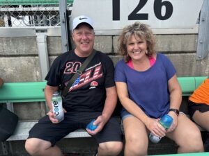 Two RaceAway guests smile from Section 126 at Kansas Speedway before the 2026 Hollywood Casino 400.