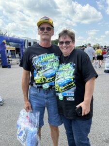 Two RaceAway guests pose together in the fan area at Darlington Raceway during the 2026 Cook Out Southern 500 weekend.