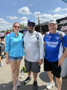 Three RaceAway guests pose in the fan midway at Darlington Raceway during the 2026 Cook Out Southern 500 weekend.