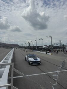 A Ford pace car rolls down pit road at Darlington Raceway during the 2026 Cook Out Southern 500 weekend, with the Cale Yarborough Garage in view.