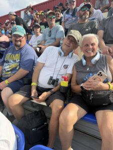 Three RaceAway guests sit together in the grandstands at Darlington Raceway during the 2026 Cook Out Southern 500.