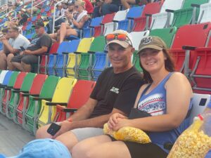 Two RaceAway guests relax in the colorful grandstands at Daytona International Speedway during the 2026 Coke Zero Sugar 400.