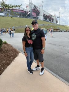 Two RaceAway guests pose outside Bristol Motor Speedway during the 2026 Bass Pro Shops Night Race weekend.