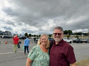 Four RaceAway guests pose near Charlotte Motor Speedway ahead of the October 2026 Bank of America 400, starting race day together before heading into the track.