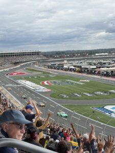 NASCAR Cup Series cars race past the grandstands at Charlotte Motor Speedway during the October 2026 Bank of America 400.
