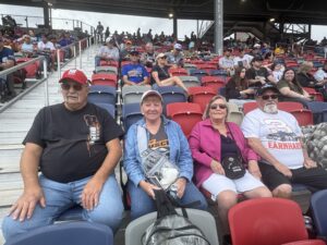 Four RaceAway guests relax in the grandstands at Phoenix Raceway before the 2026 Freeway Insurance 500.