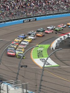 The NASCAR Cup Series field races through the dogleg at Phoenix Raceway during the 2026 Freeway Insurance 500.